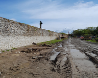 Repairs completed to lower section of wall, with works commencing to upper section.