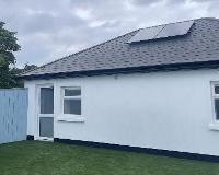The completed conversion with solar panels, new windows and doors.
